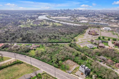 an aerial view of lake and residential houses with outdoor space