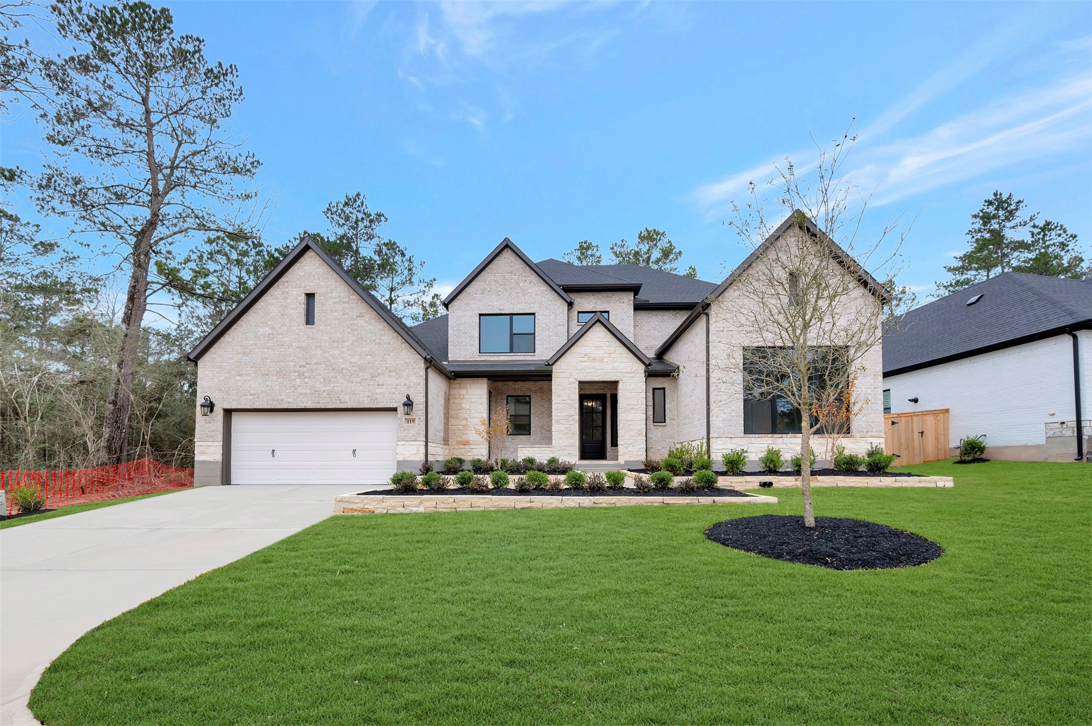 a front view of house with yard and green space