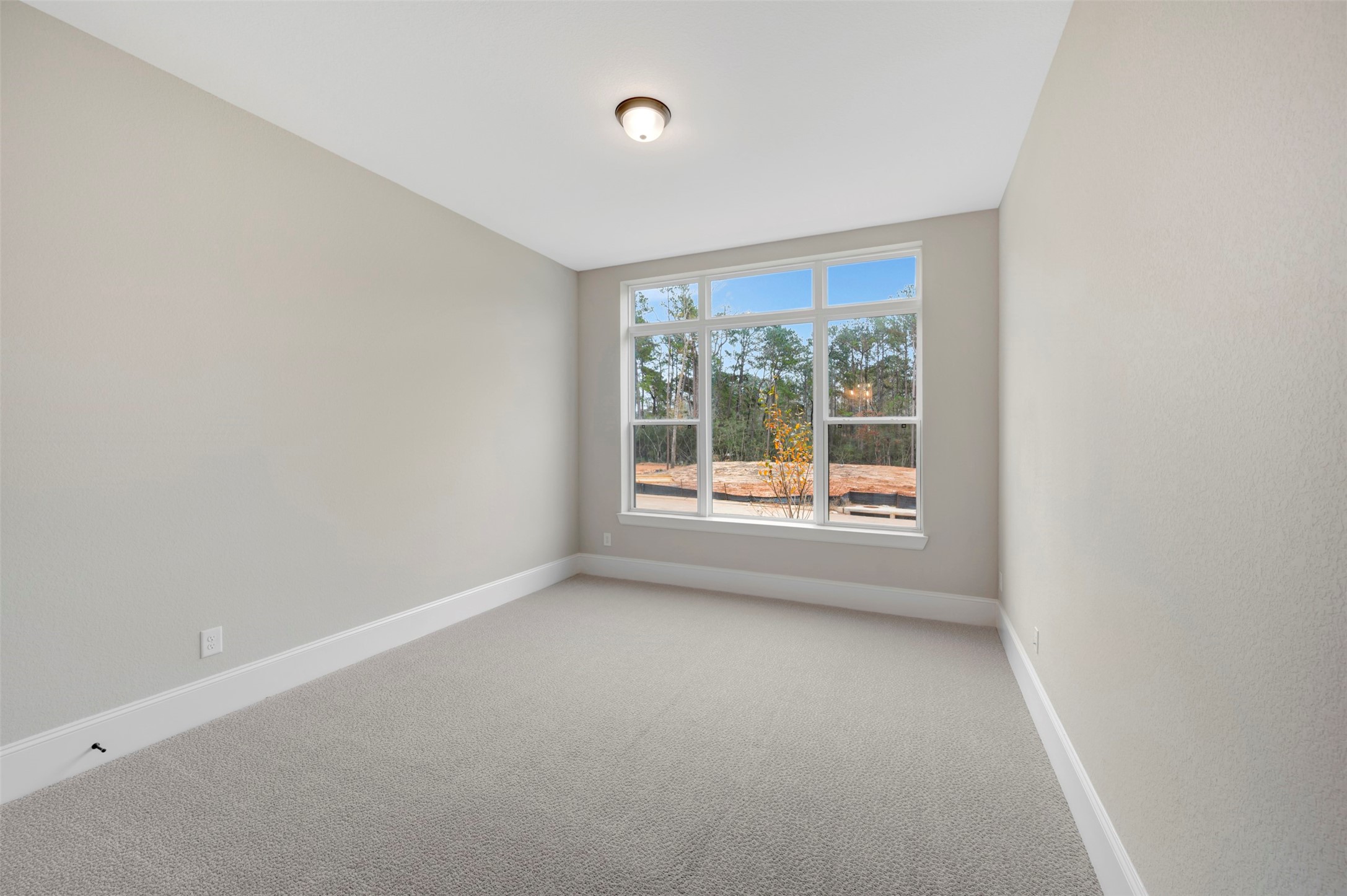 119 Rustica Bloom Trail Willis, TX 77318 - Photo 12 of 50 wooden floor in an empty room with a window