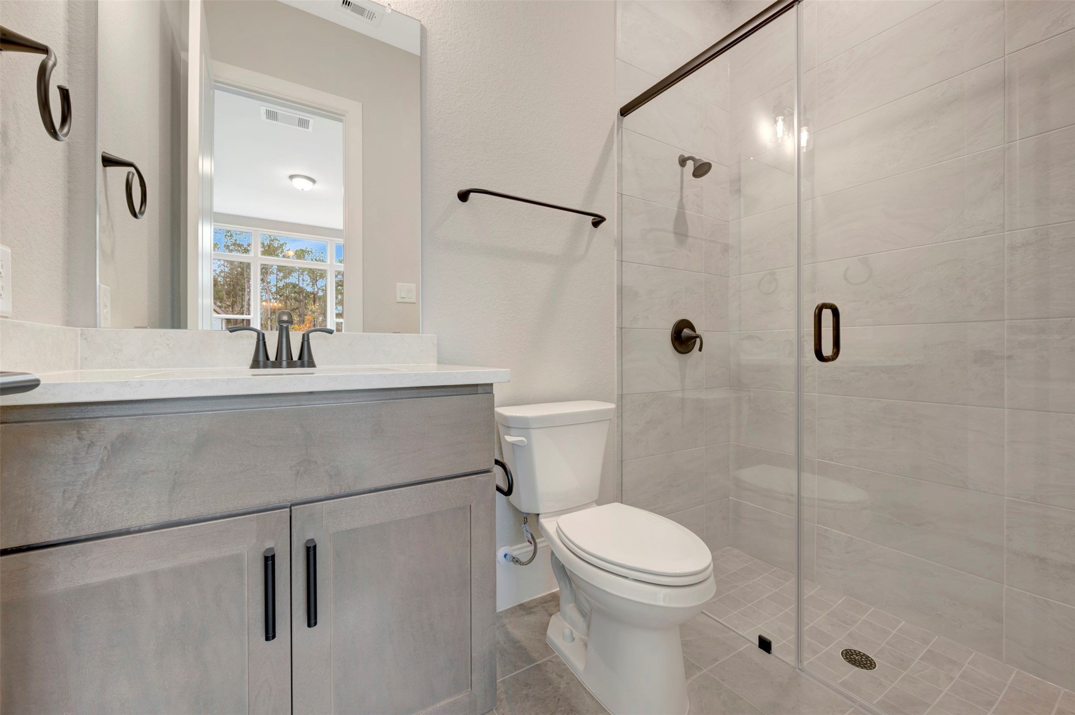 119 Rustica Bloom Trail Willis, TX 77318 - Photo 14 of 50 a bathroom with a sink a toilet and shower