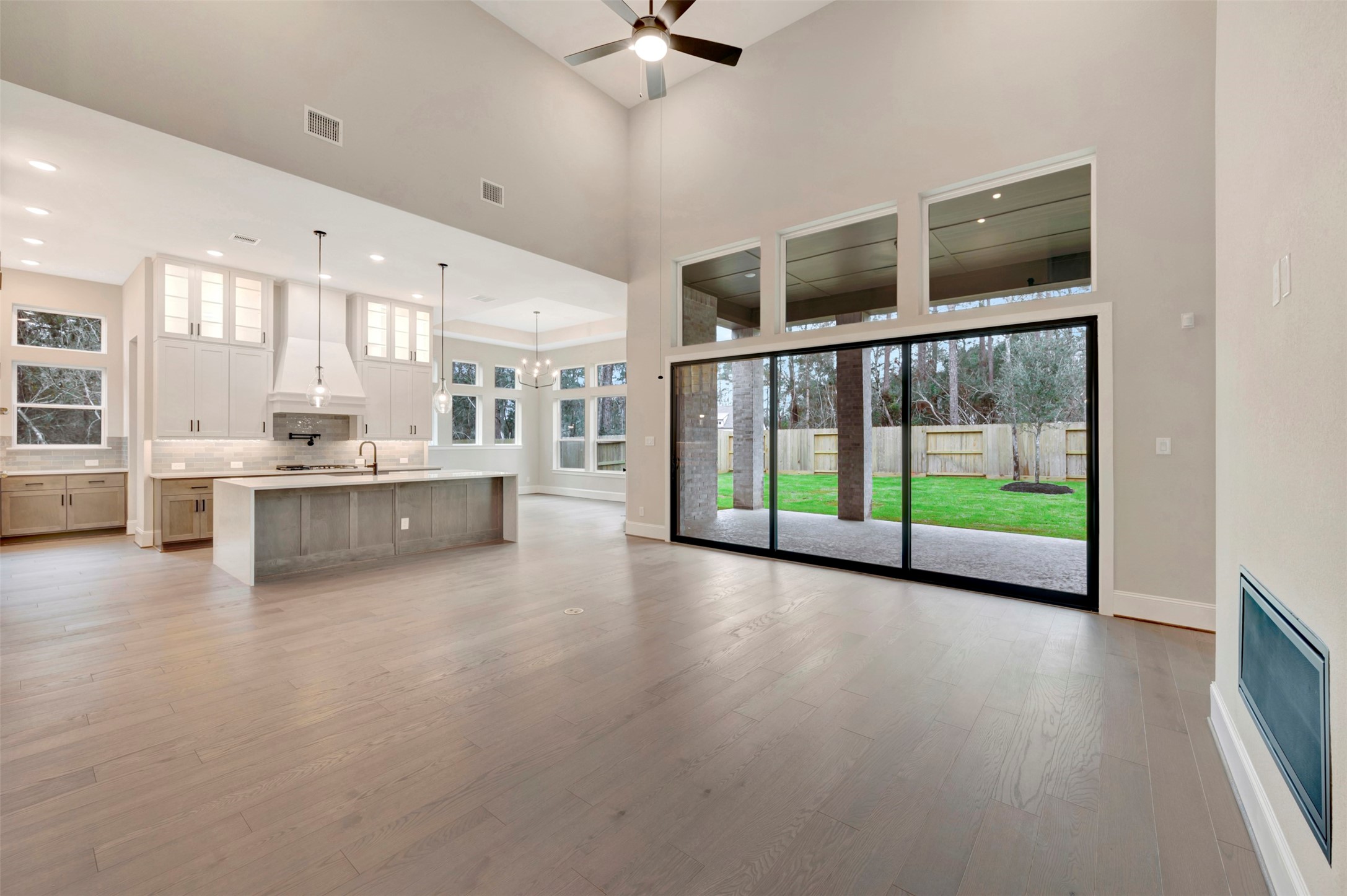 119 Rustica Bloom Trail Willis, TX 77318 - Photo 17 of 50 a view of an empty room with a kitchen and chandelier