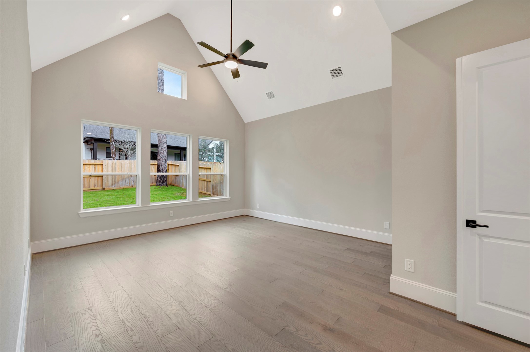 119 Rustica Bloom Trail Willis, TX 77318 - Photo 20 of 50 an empty room with windows and ceiling fan