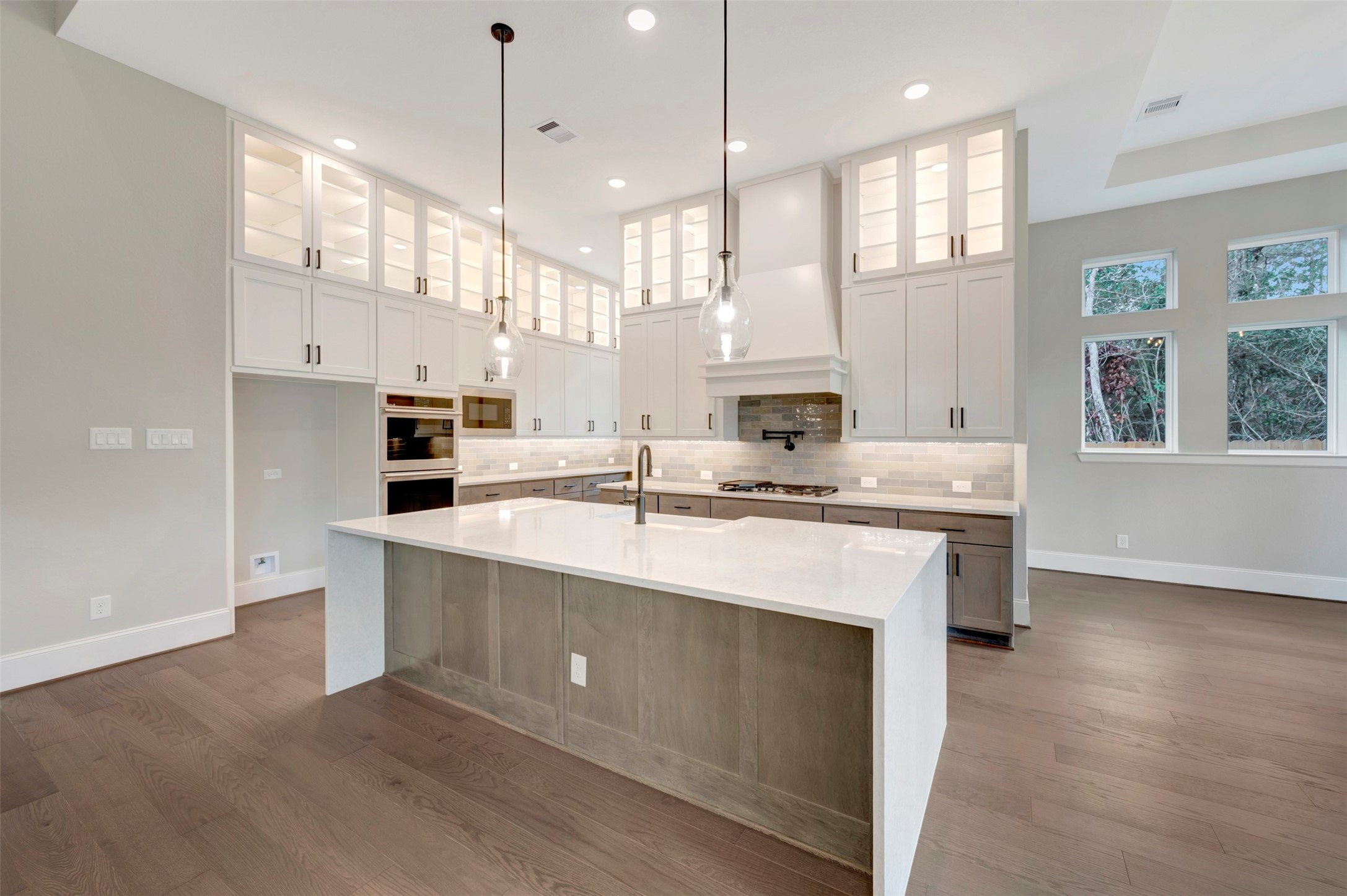 119 Rustica Bloom Trail Willis, TX 77318 - Photo 29 of 50 a kitchen with kitchen island a sink stainless steel appliances and white cabinets