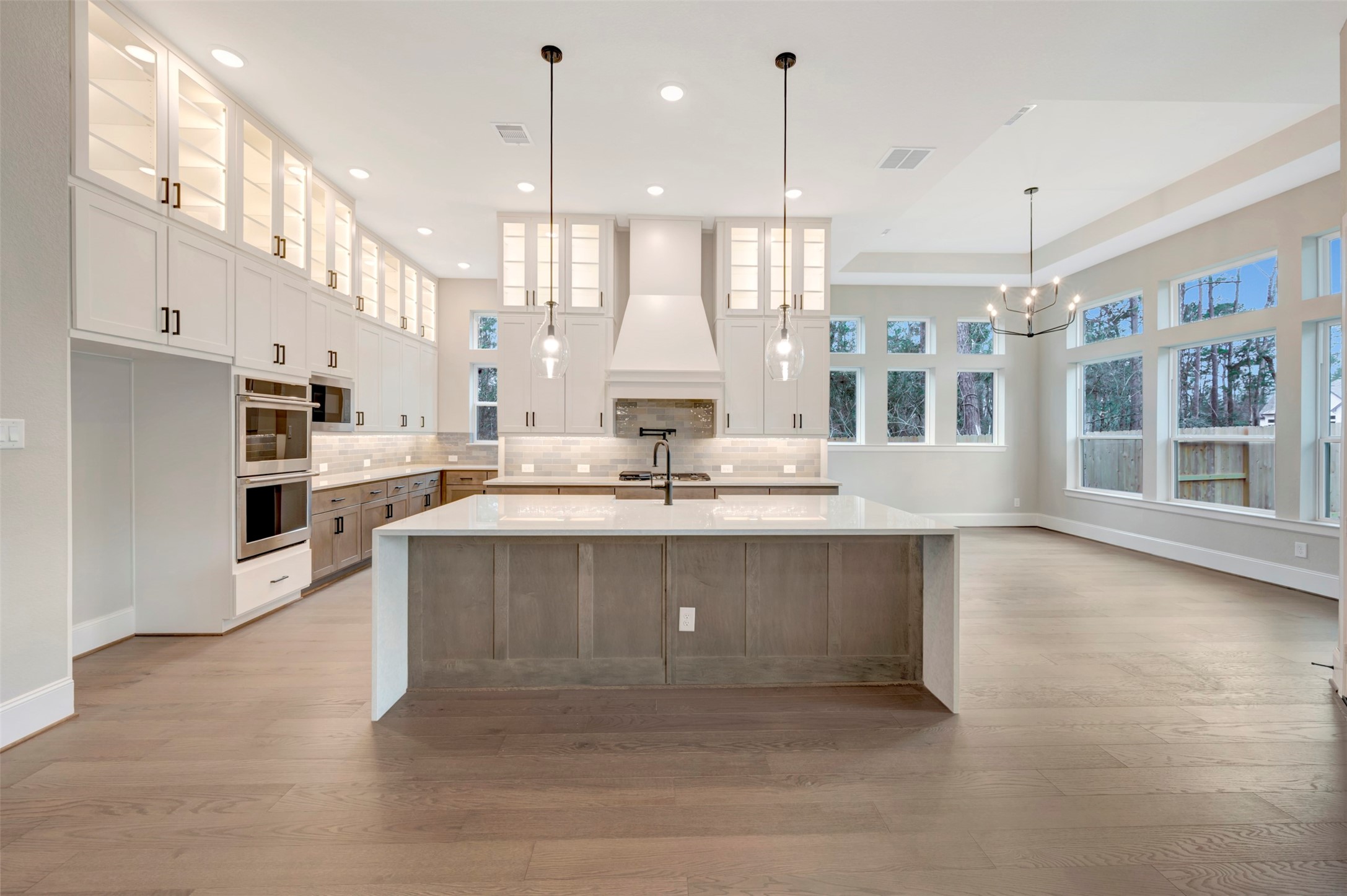 119 Rustica Bloom Trail Willis, TX 77318 - Photo 30 of 50 a large kitchen with kitchen island a large counter space a sink appliances and cabinets