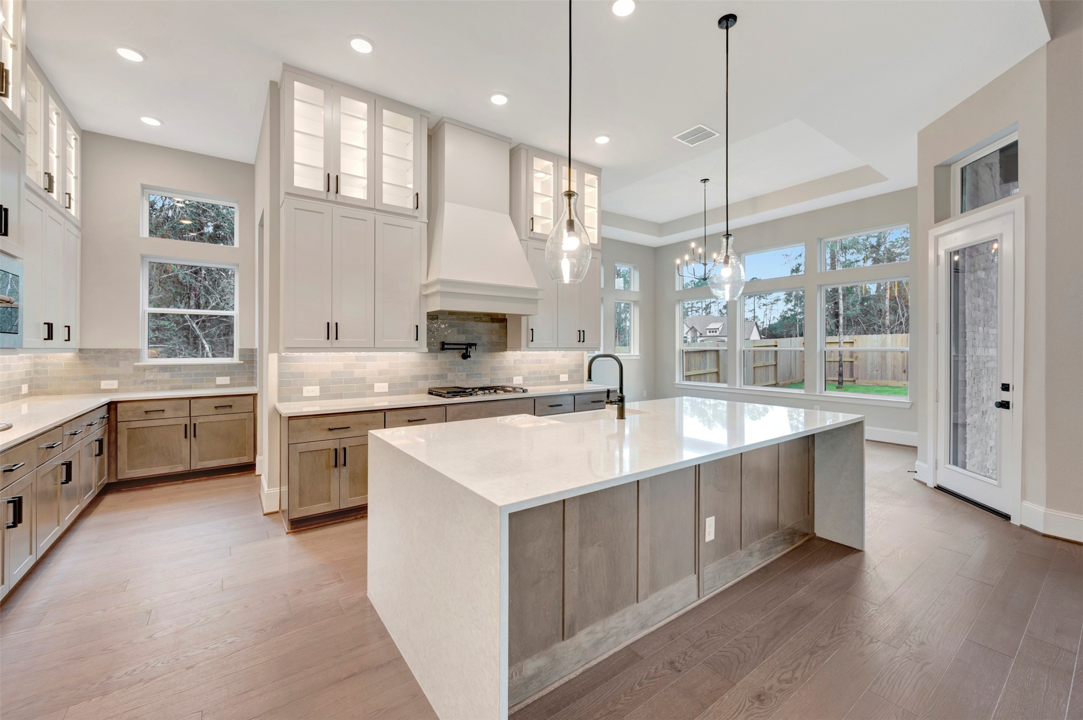 119 Rustica Bloom Trail Willis, TX 77318 - Photo 31 of 50 a large kitchen with stainless steel appliances kitchen island granite countertop a sink a counter space and a window