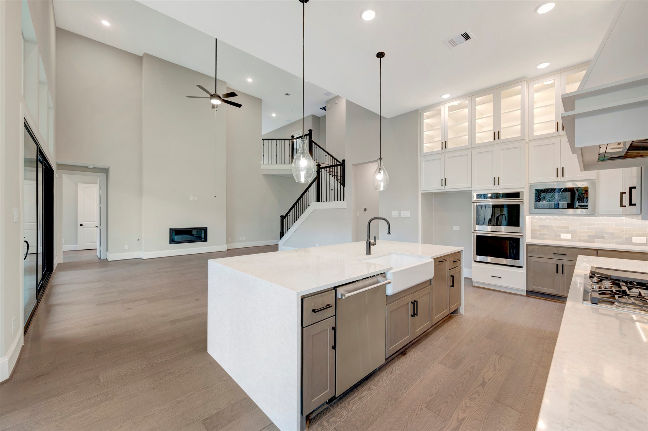 119 Rustica Bloom Trail Willis, TX 77318 - Photo 34 of 50 a large white kitchen with a stove a sink a refrigerator and a fireplace