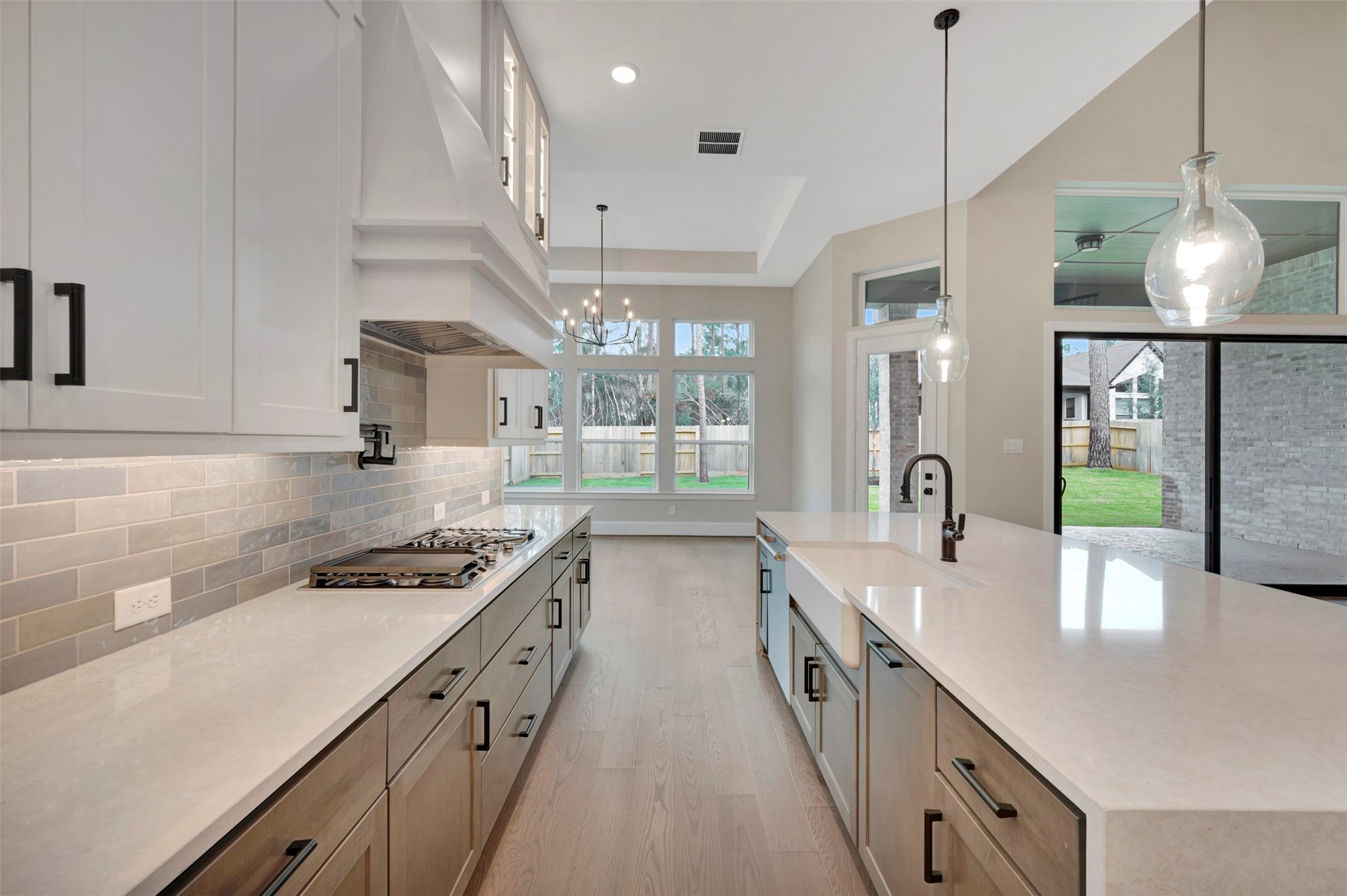 119 Rustica Bloom Trail Willis, TX 77318 - Photo 35 of 50 a kitchen with stainless steel appliances a sink a stove top oven a counter space and cabinets
