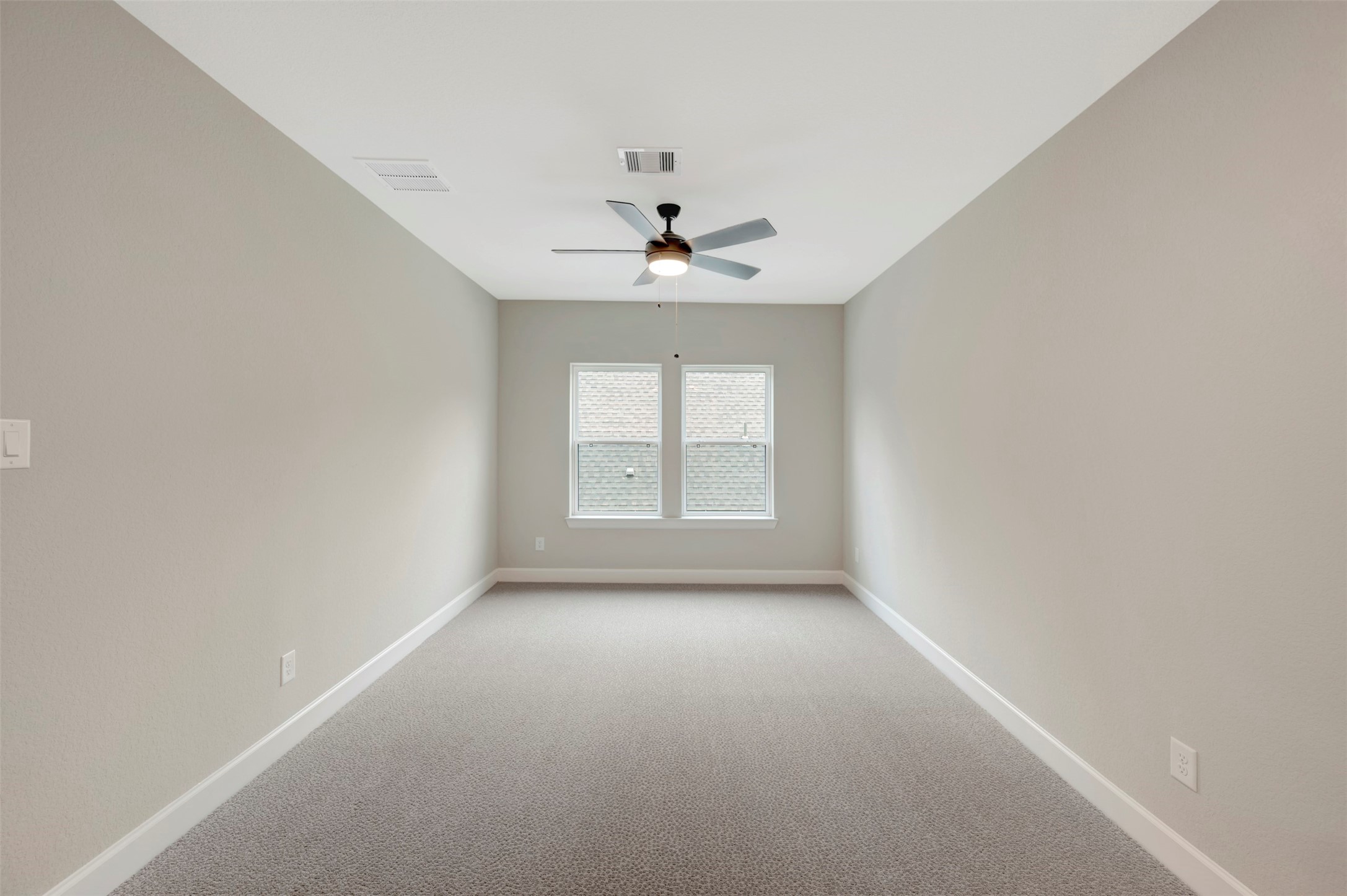 119 Rustica Bloom Trail Willis, TX 77318 - Photo 39 of 50 an empty room with a window and a ceiling fan