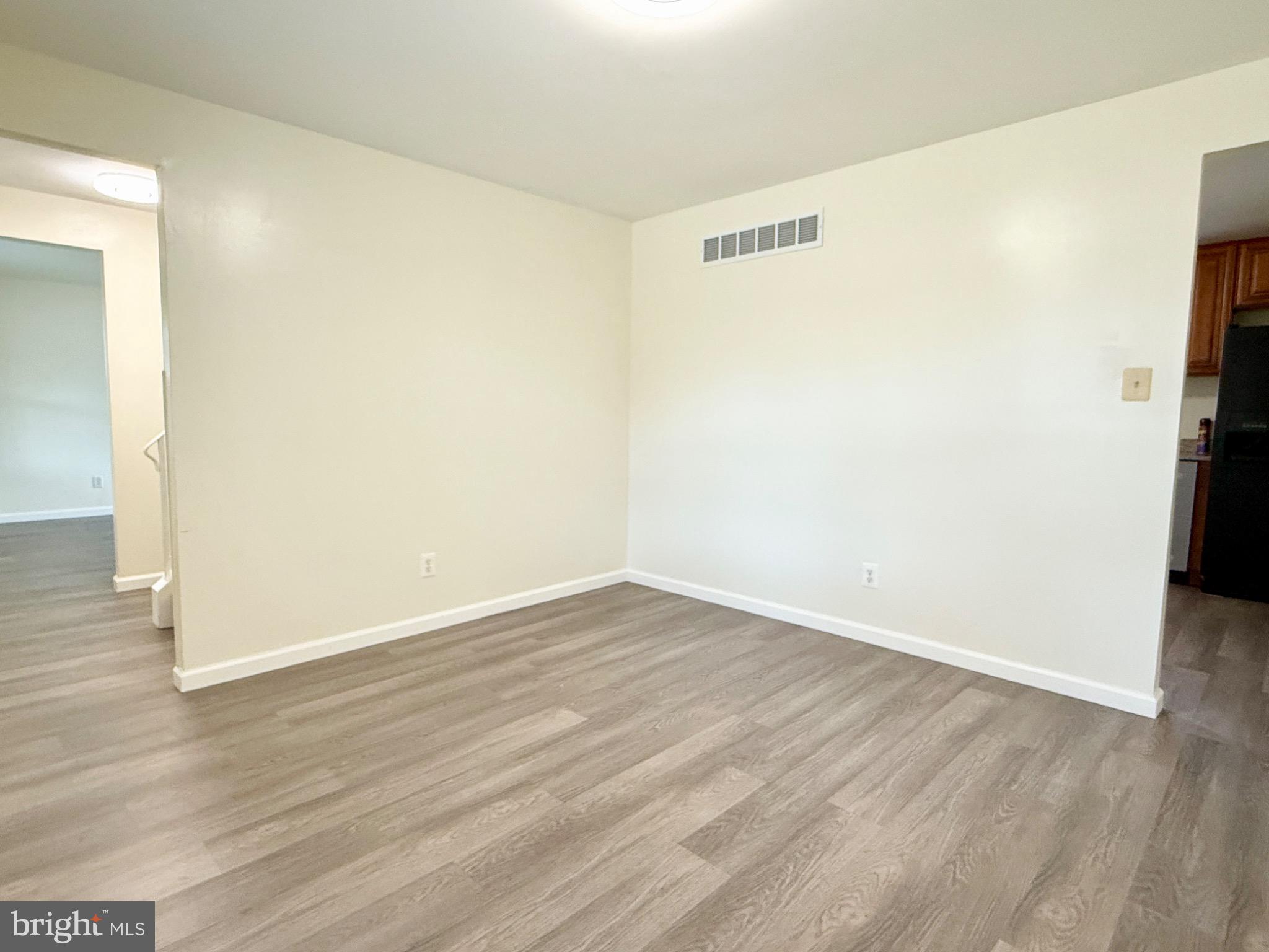 303 Oregon Avenue New Castle, DE 19720 - Photo 11 of 40 an empty room with wooden floor