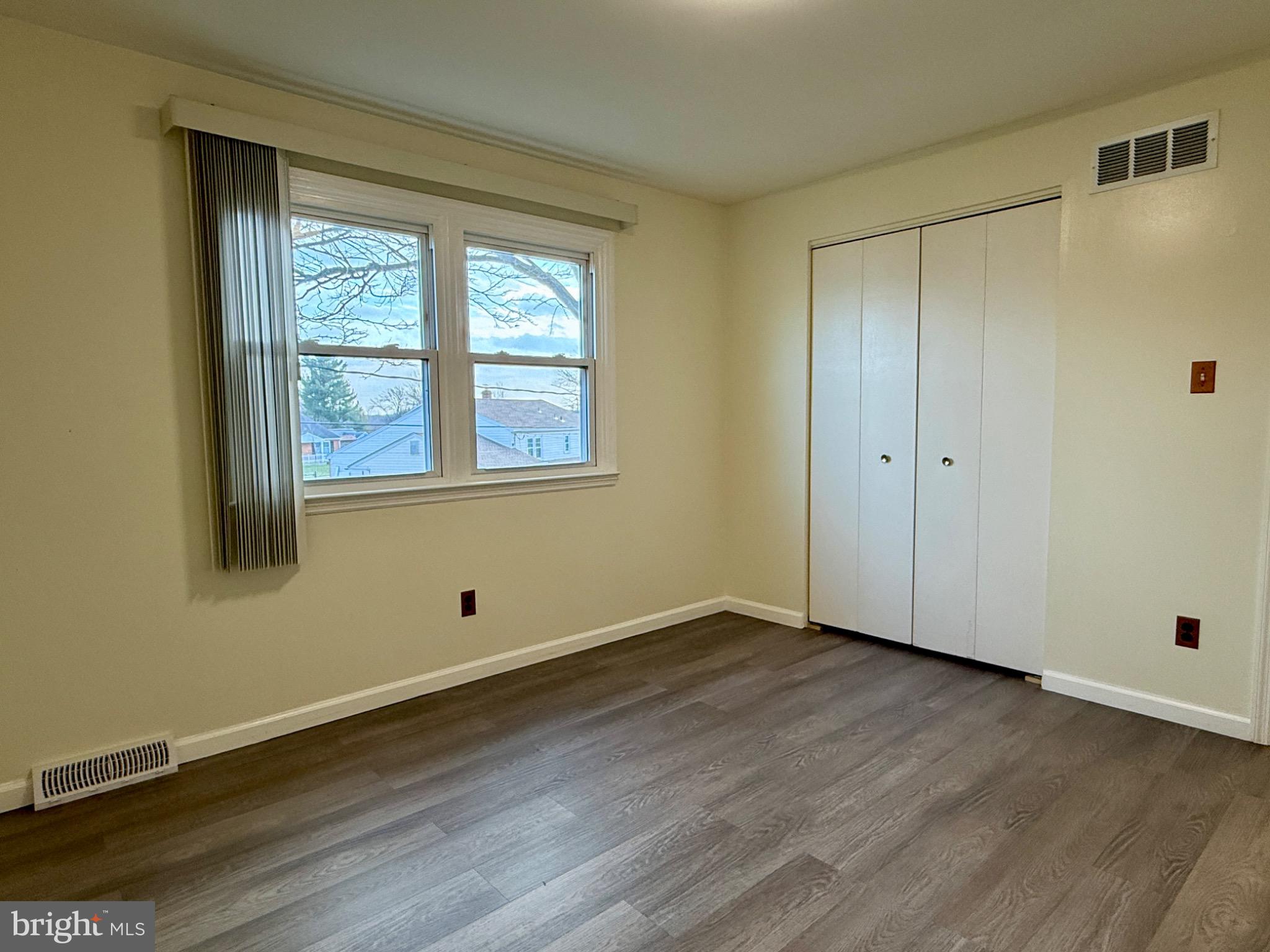 303 Oregon Avenue New Castle, DE 19720 - Photo 26 of 40 a view of an empty room with wooden floor and a window