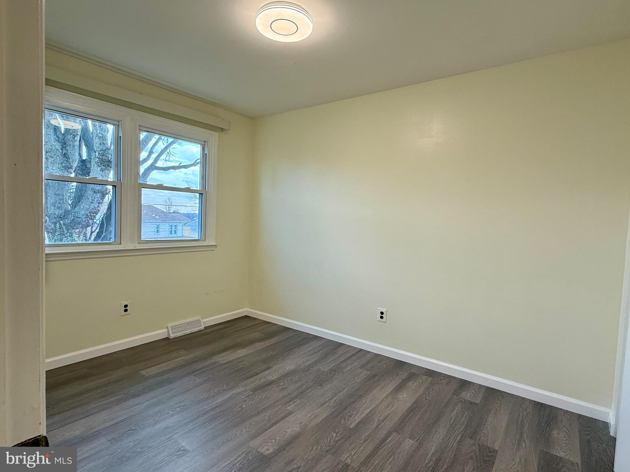 303 Oregon Avenue New Castle, DE 19720 - Photo 31 of 40 a view of a room with wooden floor and windows