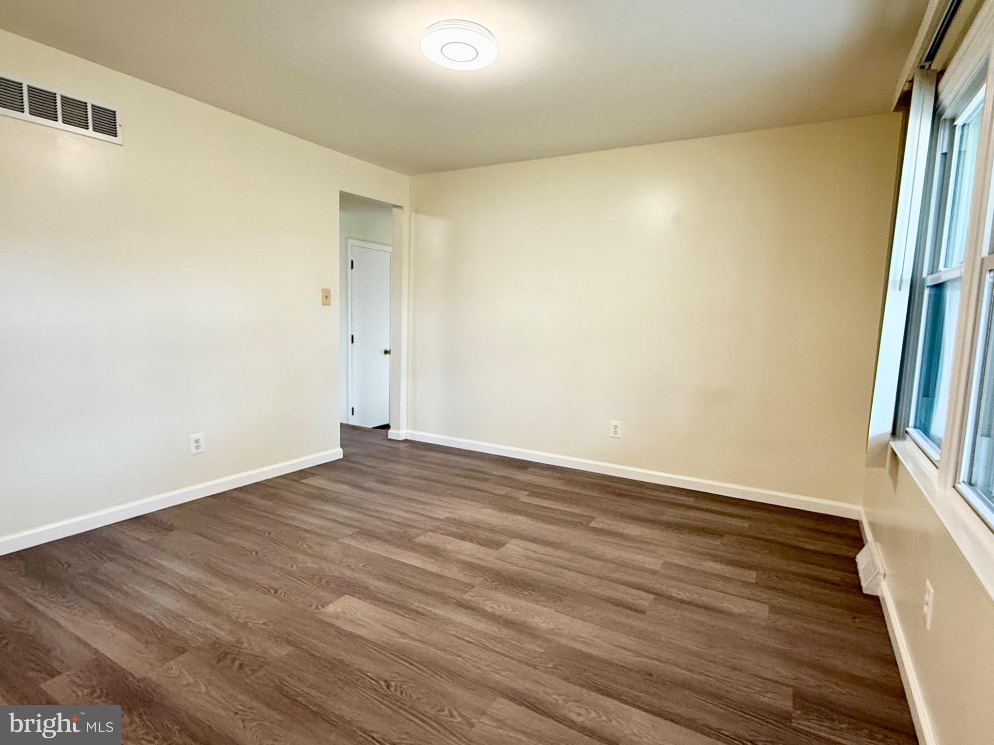 303 Oregon Avenue New Castle, DE 19720 - Photo 33 of 40 a view of an empty room with wooden floor and a window