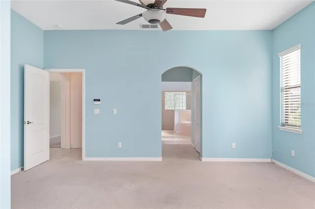 a view of a kitchen with furniture and a ceiling fan