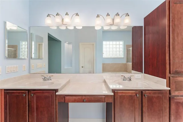 a view of a swimming pool with a patio and a yard in back