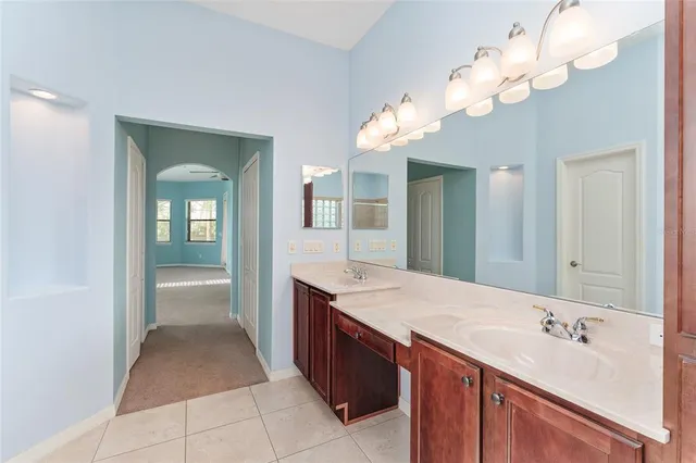 a view of a hallway with white walls and a window