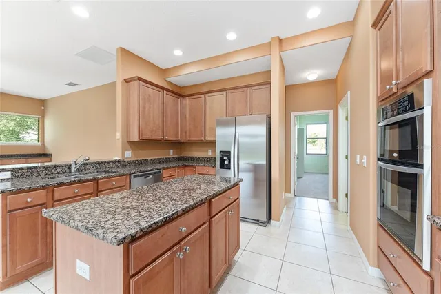 a bathroom with a granite countertop sink a toilet and shower
