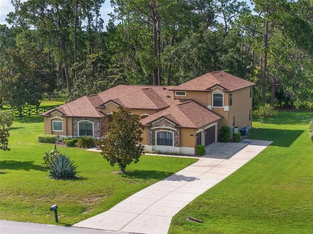 an aerial view of a residential houses with outdoor space
