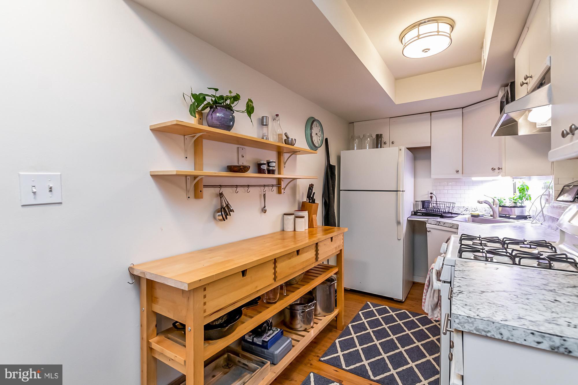 1122 William Street, Unit B Baltimore, MD 21230 - Photo 12 of 31 a kitchen with a refrigerator and a stove