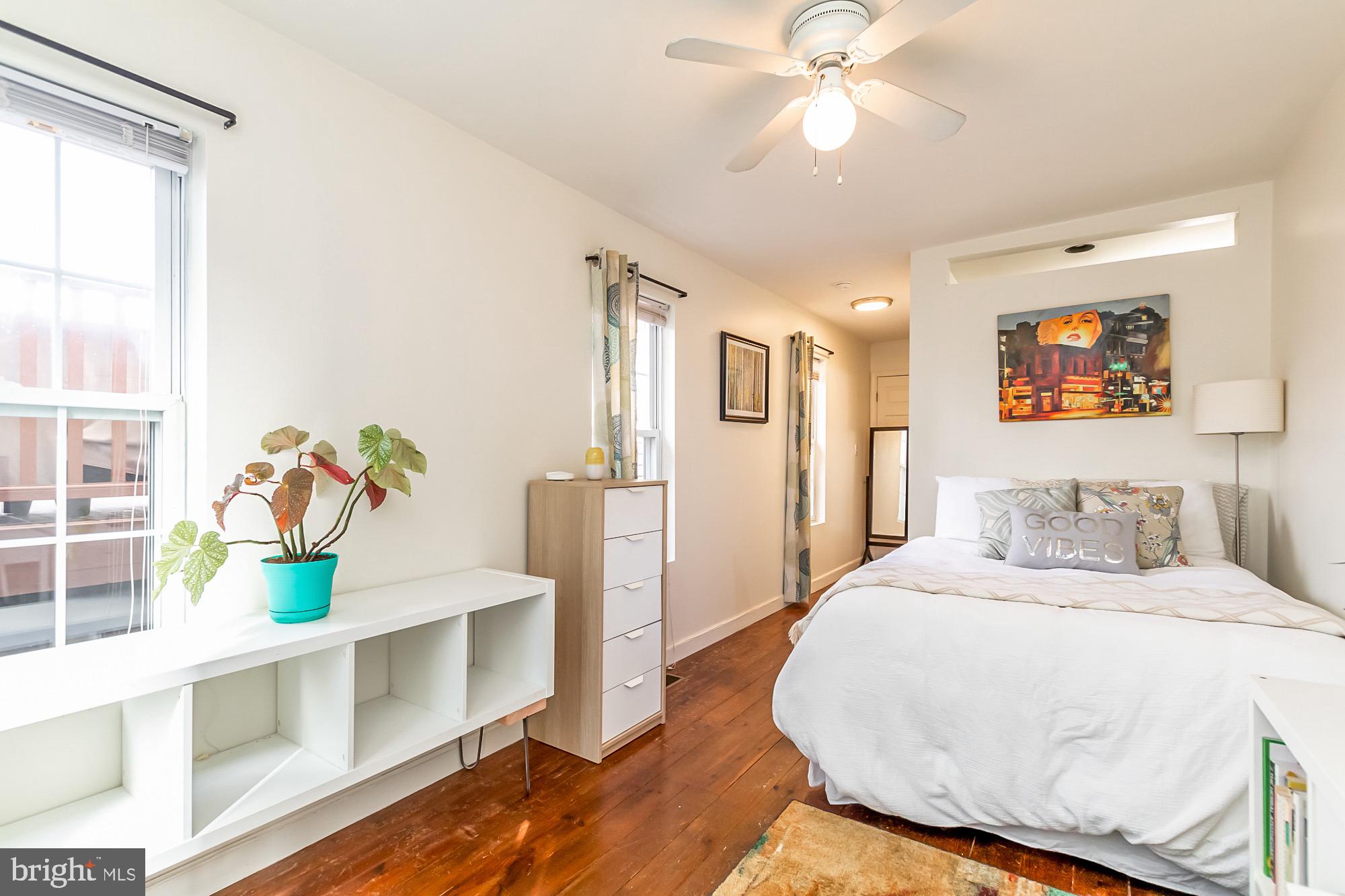 1122 William Street, Unit B Baltimore, MD 21230 - Photo 22 of 31 a bedroom with a bed and a chandelier
