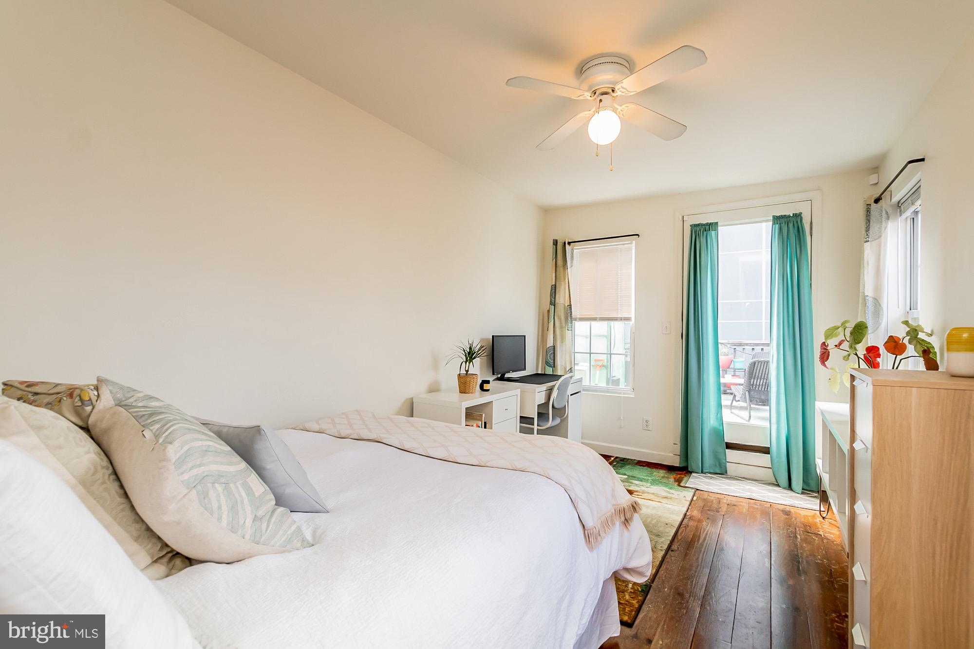 1122 William Street, Unit B Baltimore, MD 21230 - Photo 23 of 31 a bedroom with a bed and a chandelier