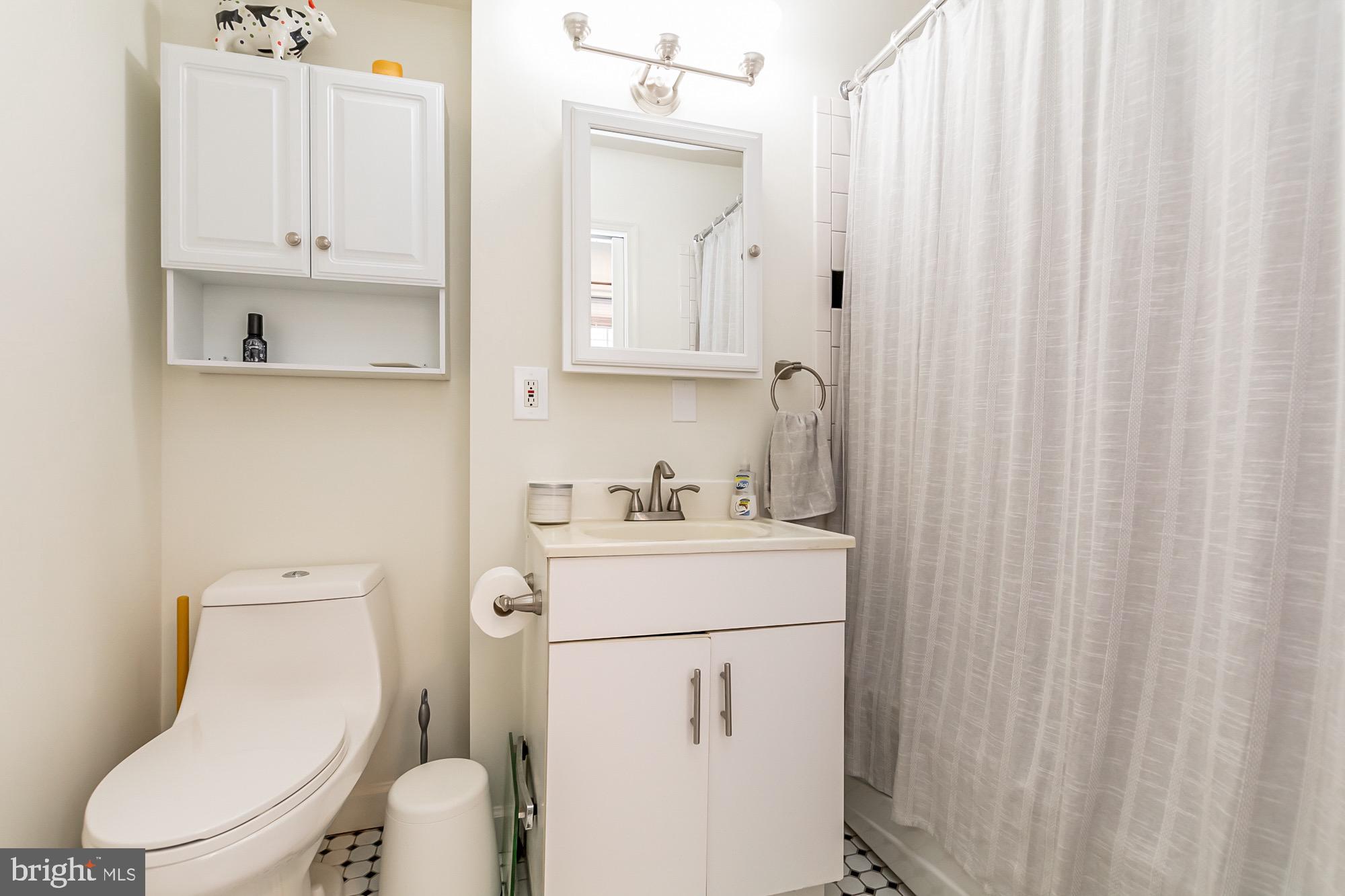 1122 William Street, Unit B Baltimore, MD 21230 - Photo 25 of 31 a white toilet sitting next to a bathroom sink