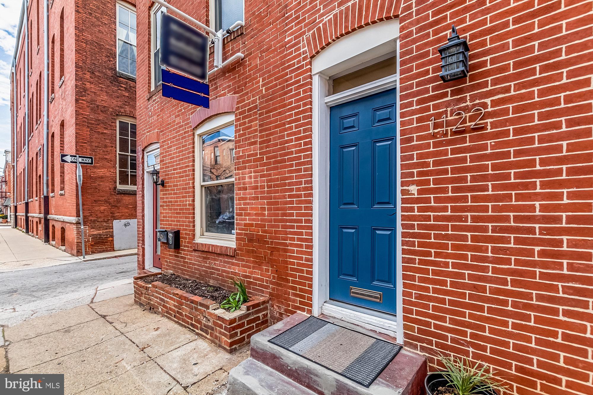 1122 William Street, Unit B Baltimore, MD 21230 - Photo 29 of 31 a view of a brick building with many windows