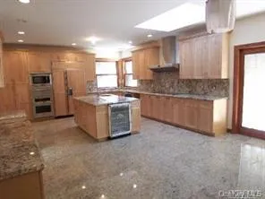a kitchen with stainless steel appliances granite countertop a stove and a refrigerator