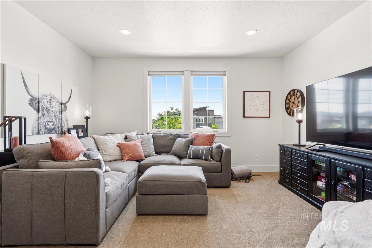 3794 South Single Tree Avenue Boise, ID 83716 - Photo 35 of 50 Spacious living area featuring neutral carpeting, recessed lighting, and large windows providing ample natural light