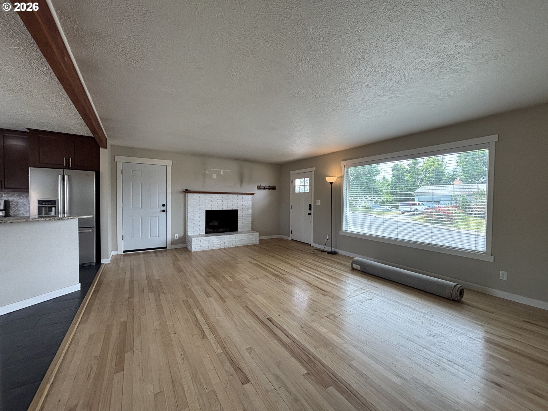 924 Southwest 33rd Street Pendleton, OR 97801 - Photo 2 of 27 a view of empty room with wooden floor and fireplace