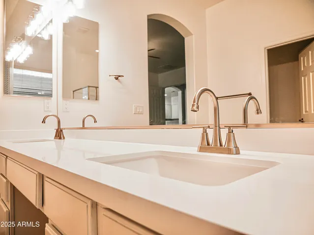 a bathroom with a double vanity sink and a mirror
