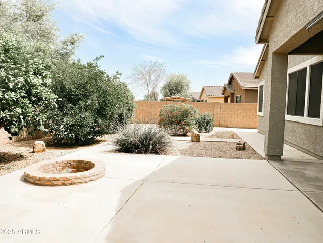 a view of a house with yard and sitting area
