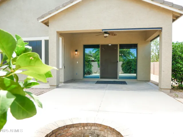 a view of a house with potted plants
