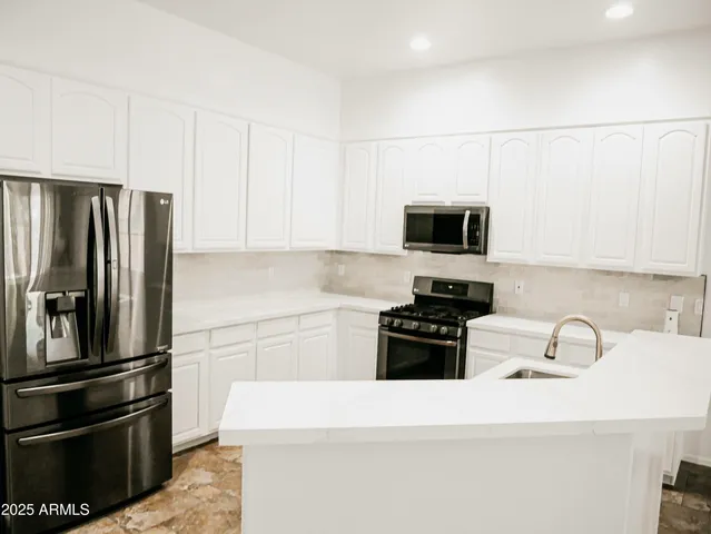 a kitchen with a refrigerator stove and microwave