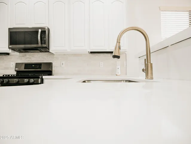 a view of a kitchen with a sink and a microwave