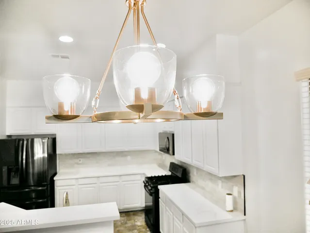 a room with a sink a stove and a mirror