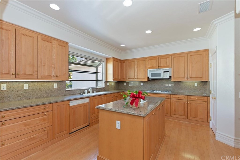 2432 Prospect Drive Upland, CA 91784 - Photo 13 of 46 a kitchen with stainless steel appliances granite countertop a sink dishwasher and cabinets with wooden floor