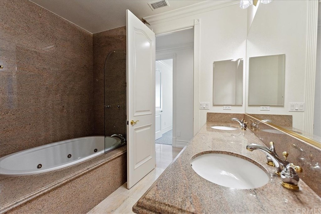 2432 Prospect Drive Upland, CA 91784 - Photo 22 of 46 a bathroom with a granite countertop tub sink and mirror