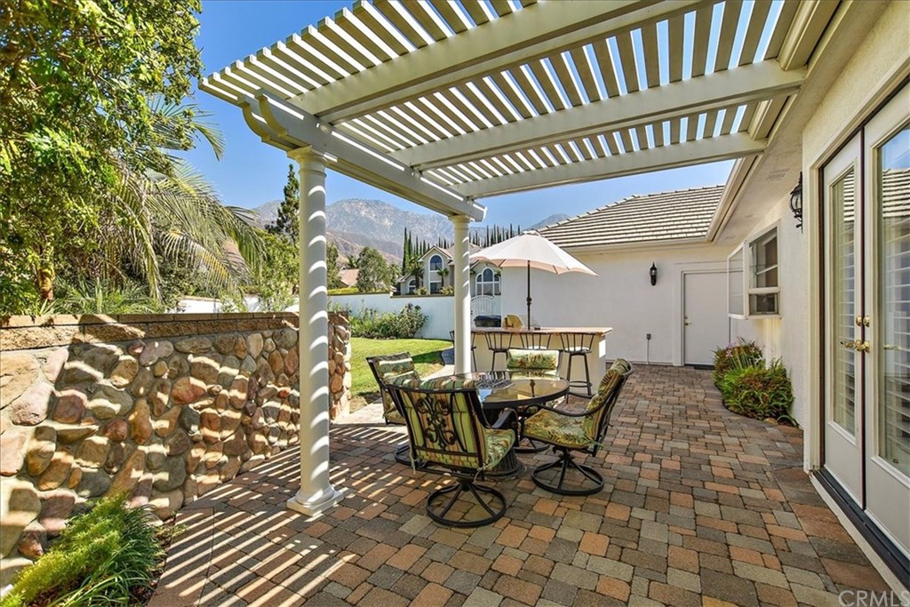 2432 Prospect Drive Upland, CA 91784 - Photo 28 of 46 a view of a patio with table and chairs and potted plants with wooden floor