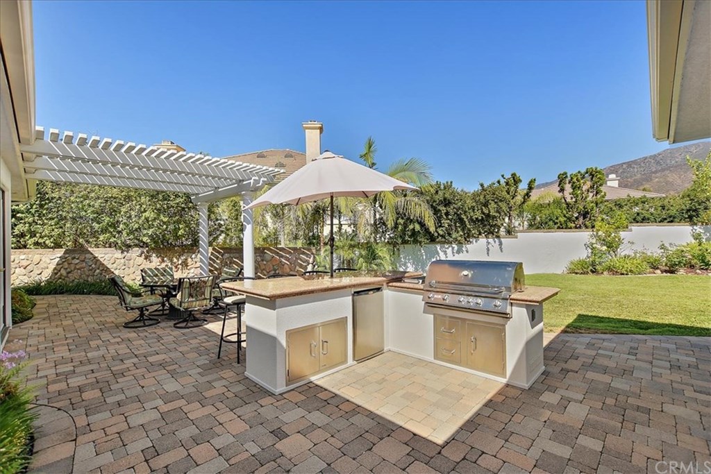 2432 Prospect Drive Upland, CA 91784 - Photo 29 of 46 a view of a patio with table and chairs under an umbrella