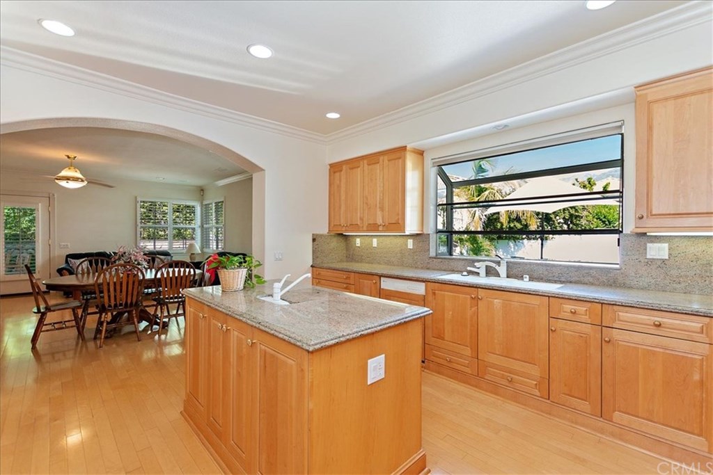 2432 Prospect Drive Upland, CA 91784 - Photo 9 of 46 a kitchen that has a lot of cabinets a sink in it and wooden floors