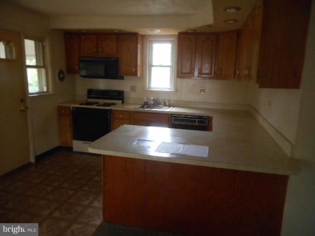 6313 Fieldvale Road Baltimore, MD 21237 - Photo 4 of 30 a kitchen with granite countertop a refrigerator and a stove top oven