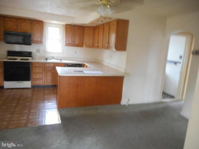 6313 Fieldvale Road Baltimore, MD 21237 - Photo 7 of 30 a kitchen with granite countertop a sink a stove top oven a counter space and cabinets