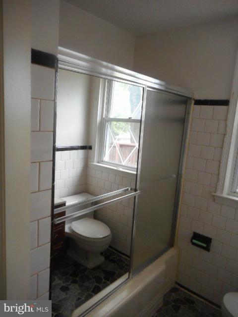 6313 Fieldvale Road Baltimore, MD 21237 - Photo 10 of 30 a bathroom with a toilet and a shower