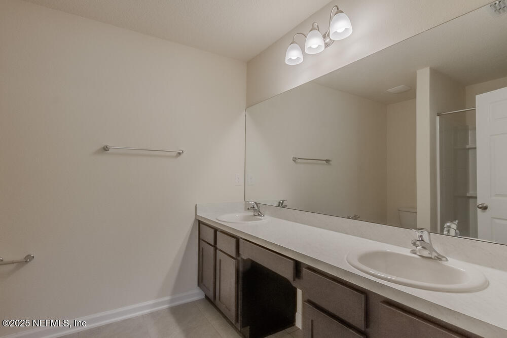 97 Coastline Way Street St. Augustine, FL 32092 - Photo 11 of 31 a bathroom with a sink a vanity and a mirror