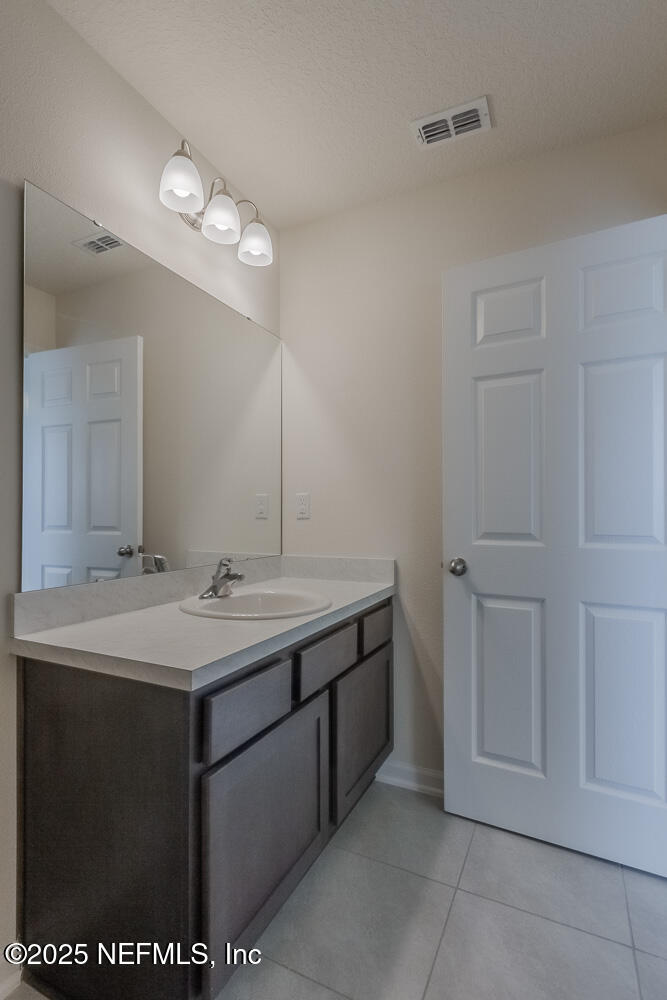 97 Coastline Way Street St. Augustine, FL 32092 - Photo 14 of 31 a bathroom with a sink and a mirror