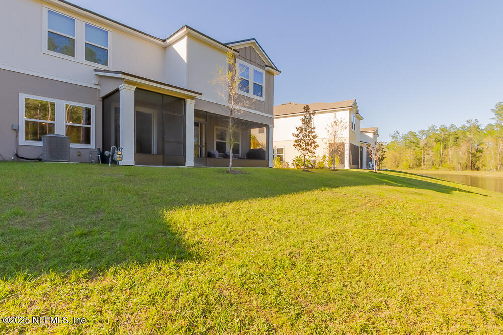 97 Coastline Way Street St. Augustine, FL 32092 - Photo 19 of 31 a view of a building with a yard