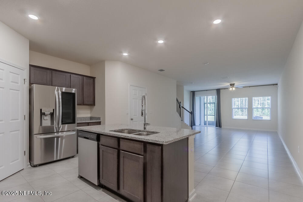 97 Coastline Way Street St. Augustine, FL 32092 - Photo 2 of 31 a kitchen with kitchen island a sink appliances and cabinets