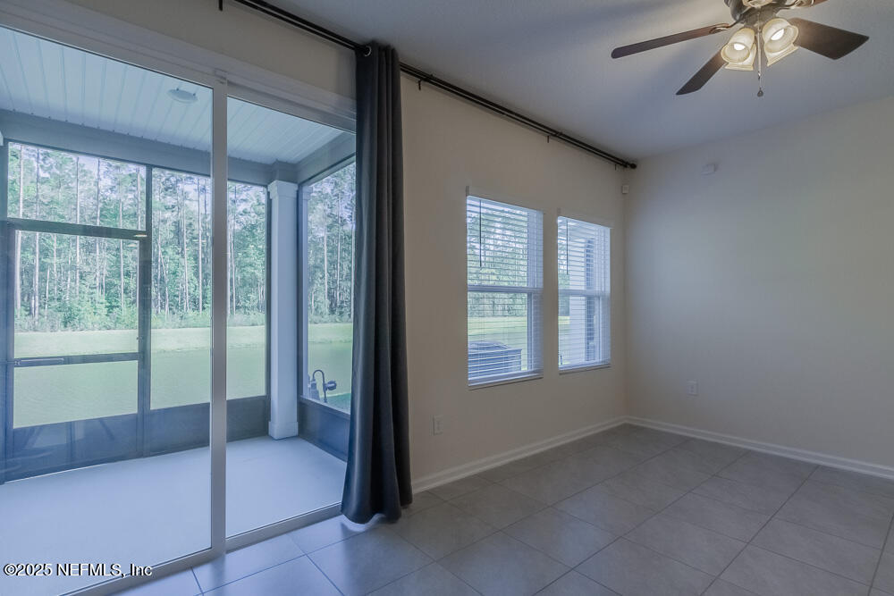 97 Coastline Way Street St. Augustine, FL 32092 - Photo 7 of 31 a spacious bedroom with a bed and a chandelier