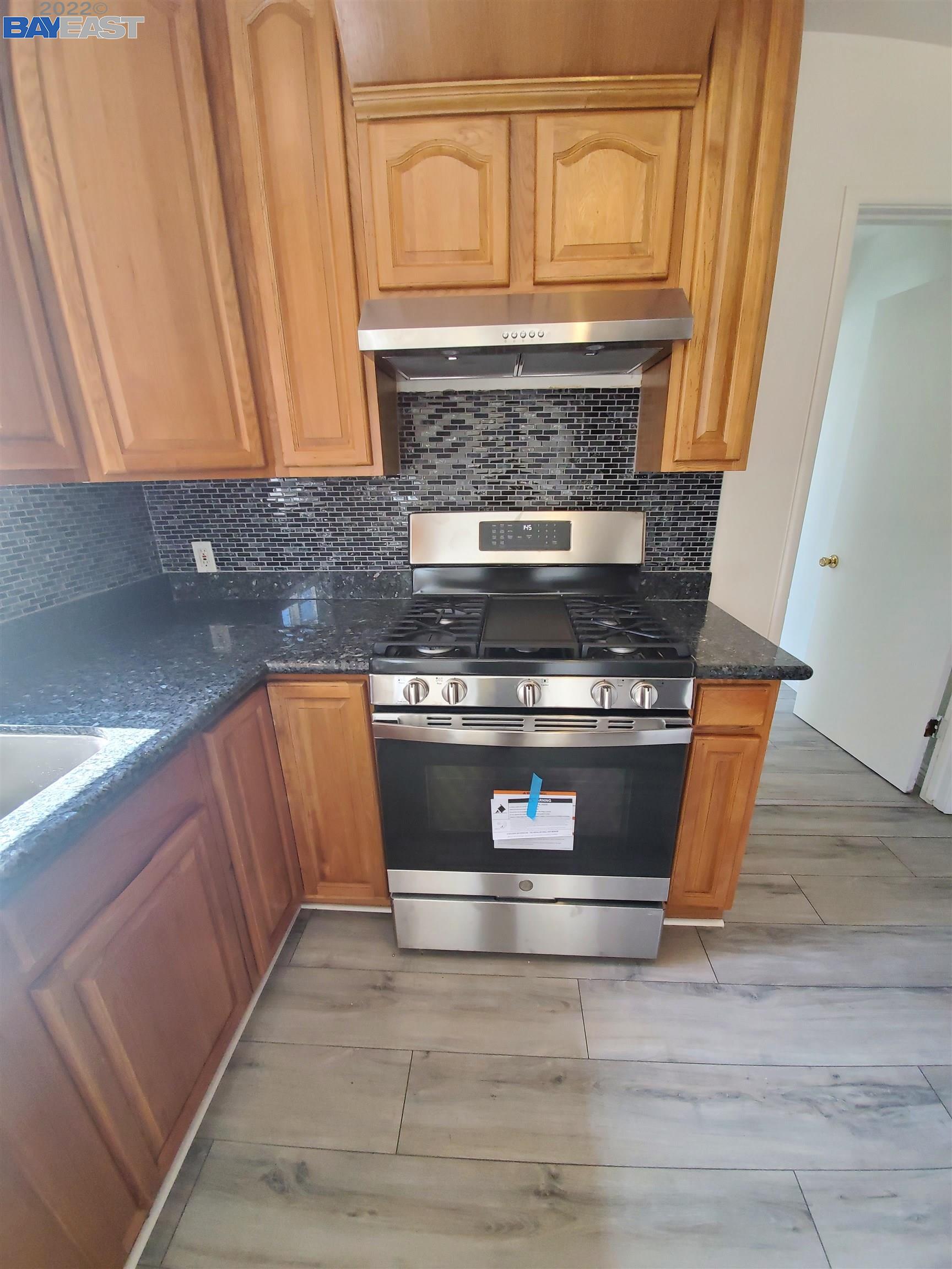 1869 E Street Hayward, CA 94541 - Photo 15 of 22 a stove top oven sitting inside of a kitchen