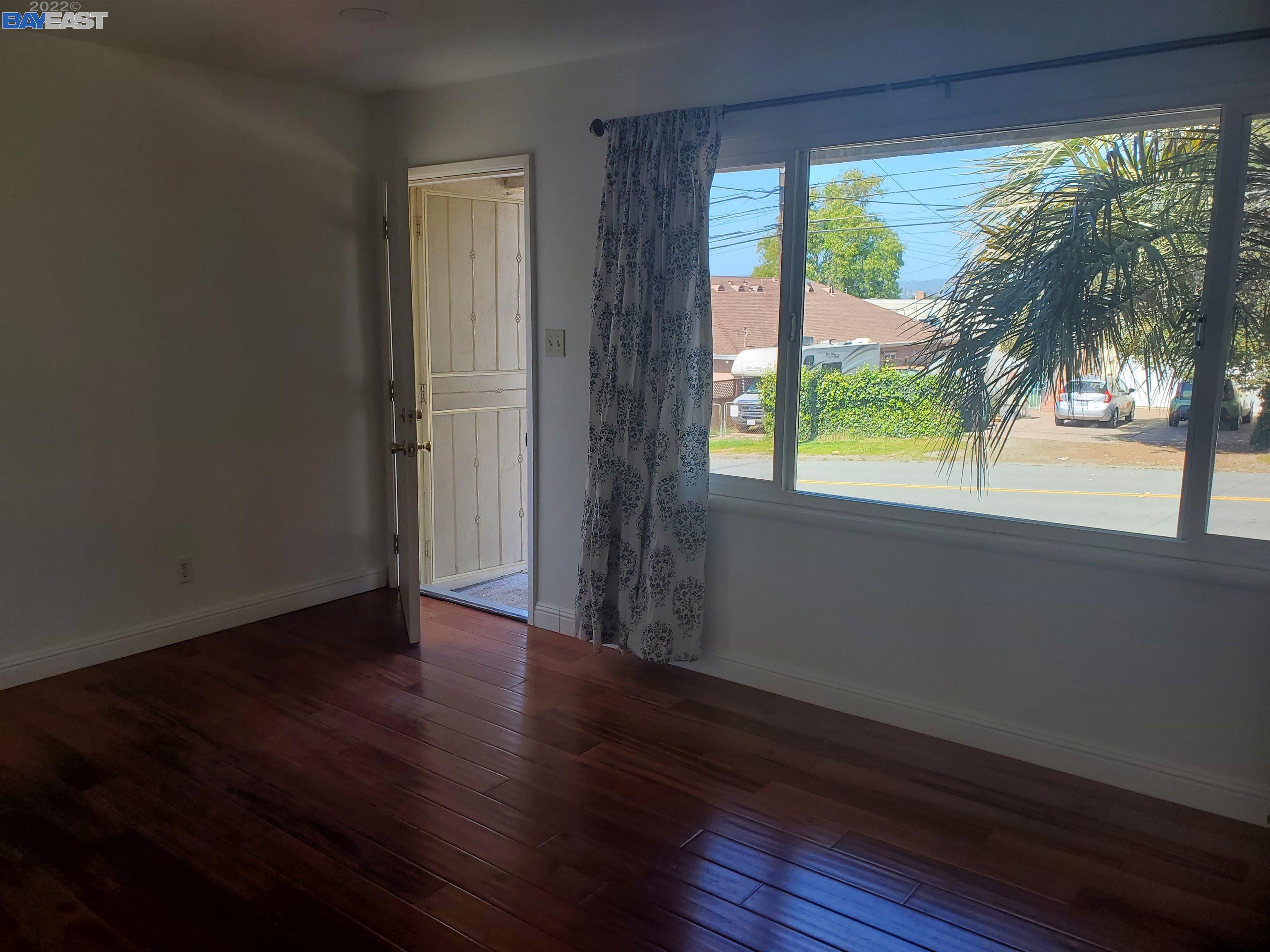 1869 E Street Hayward, CA 94541 - Photo 2 of 22 a view of a room with wooden floor and a floor to ceiling window